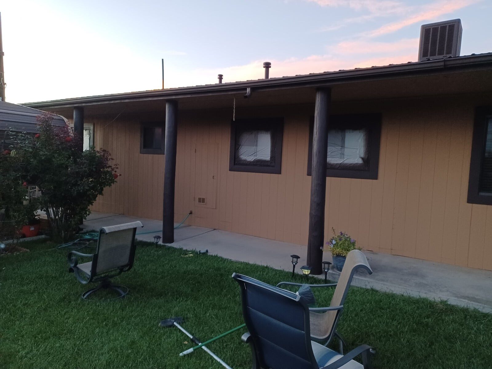 Freshly painted home exterior with tidy landscaping and patio