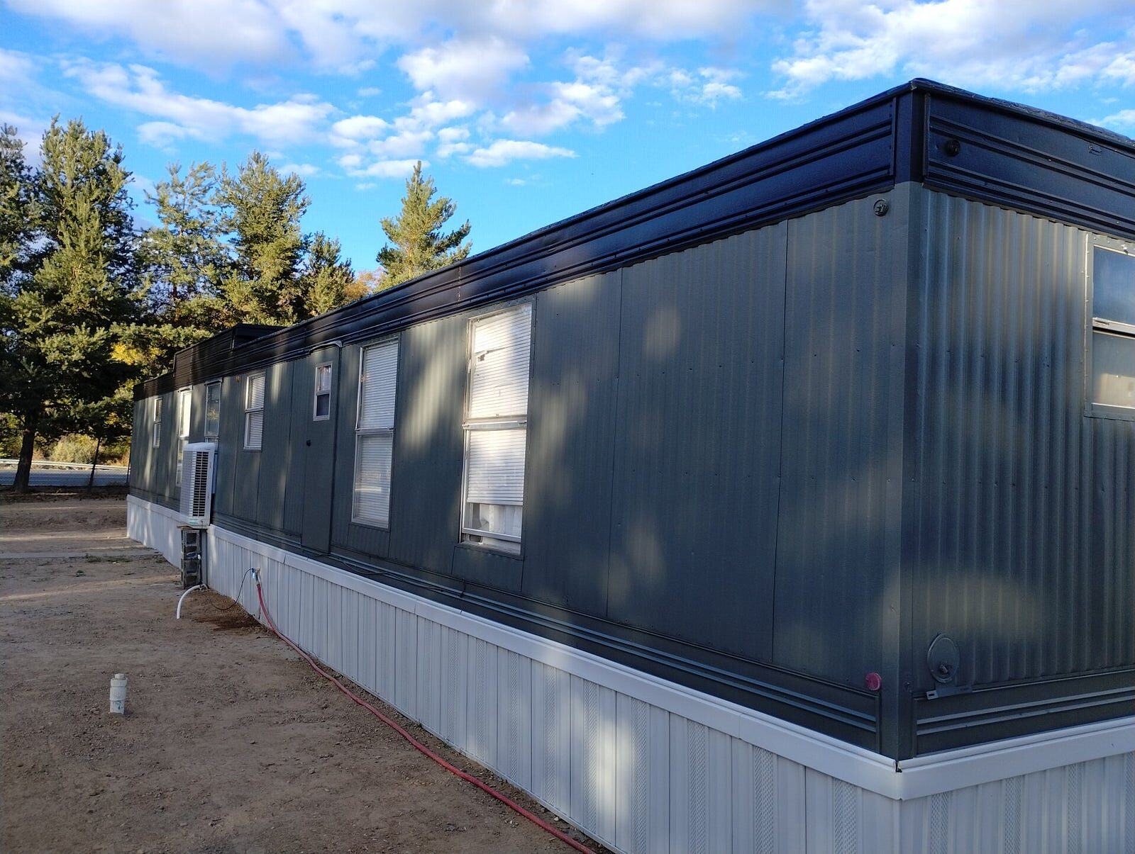 Clean modern gray home exterior repainted by Aragon's